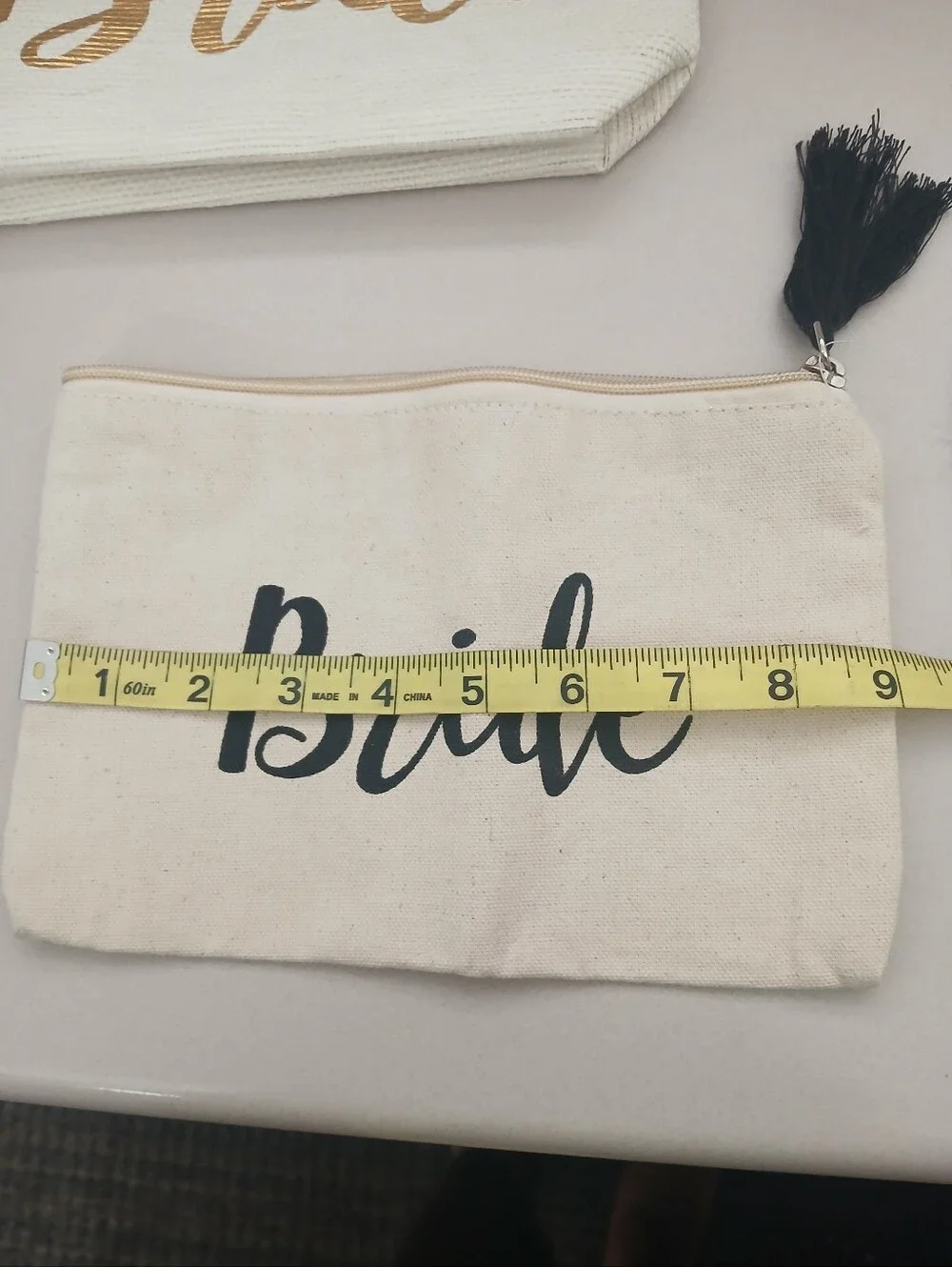 Shiraleah Cream Canvas Pouch with Gold Script and Pom Pom
